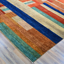 Load image into Gallery viewer, Colorful striped rug on a wooden floor