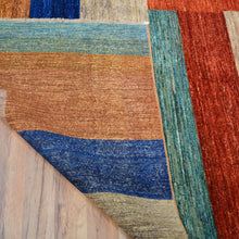 Load image into Gallery viewer, Close-up of a multicolored textured rug on a wooden floor