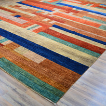 Load image into Gallery viewer, Colorful geometric-patterned rug on a wooden floor