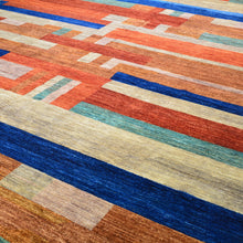 Load image into Gallery viewer, Close-up of a multicolored striped rug with orange, blue, beige, and brown tones.