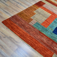 Load image into Gallery viewer, Geometric patterned rug on a wooden floor