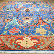 Load image into Gallery viewer, Colorful patterned rug with intricate designs on a wooden floor.