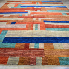 Load image into Gallery viewer, Multicolored geometric patterned rug on a wooden floor
