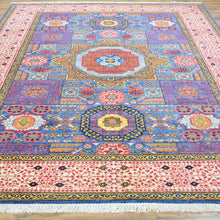 Load image into Gallery viewer, Colorful patterned rug with intricate designs on a wooden floor