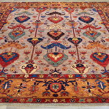 Load image into Gallery viewer, Colorful patterned rug with intricate designs on a wooden floor.
