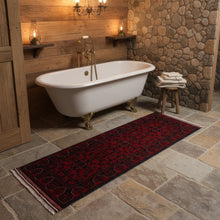 Load image into Gallery viewer, Red patterned rug on a wooden floor