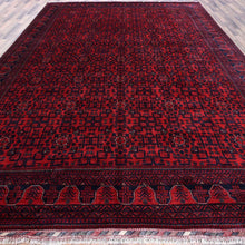 Load image into Gallery viewer, Red patterned rug on a checkered floor