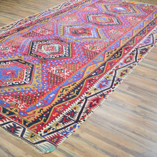 Load image into Gallery viewer, Colorful patterned rug on a wooden floor