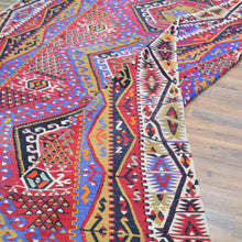Load image into Gallery viewer, Colorful patterned rug on a wooden floor