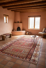 Load image into Gallery viewer, Decorative rug with intricate patterns on a wooden floor