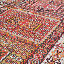 Load image into Gallery viewer, Close-up of a colorful patterned rug with intricate designs.