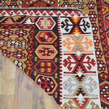 Load image into Gallery viewer, Close-up of a patterned rug with geometric designs on a wooden floor.