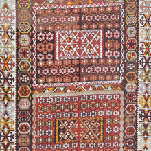 Load image into Gallery viewer, Close-up of a traditional patterned fabric with geometric designs.