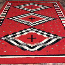 Load image into Gallery viewer, Red rug with black and white geometric pattern on a wooden floor