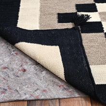 Load image into Gallery viewer, Close-up of a checkered rug with black, white, and gray pattern on a wooden floor.