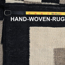 Load image into Gallery viewer, Close-up of a hand-woven rug with a measuring tape and text overlay.