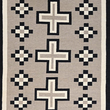 Load image into Gallery viewer, Rug with geometric pattern featuring crosses and diamond shapes on a beige background