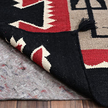 Load image into Gallery viewer, Close-up of a patterned rug with geometric design on a wooden floor.
