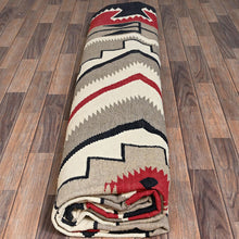 Load image into Gallery viewer, Roll of patterned fabric on a wooden floor