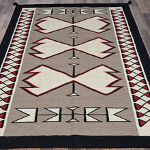Load image into Gallery viewer, Decorative rug with geometric pattern on a wooden floor