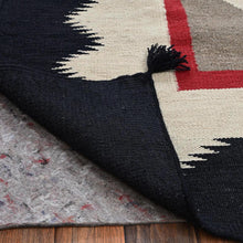Load image into Gallery viewer, Close-up of a patterned rug with geometric design on a wooden floor.