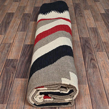 Load image into Gallery viewer, Folded blanket with red, black, and gray stripes on a wooden floor