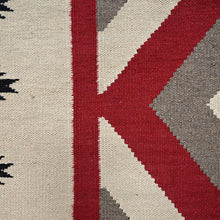 Load image into Gallery viewer, Close-up of a geometric patterned rug with red, gray, and beige colors.