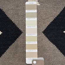 Load image into Gallery viewer, Pantone color swatch on a textured brown and black surface