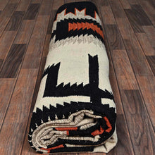 Load image into Gallery viewer, Decorative rug with geometric pattern on a wooden floor