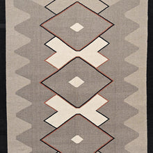Load image into Gallery viewer, Geometric patterned rug with diamond shapes and zigzag border on a plain background