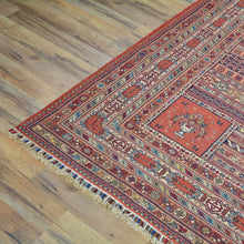 Load image into Gallery viewer, Decorative rug with intricate patterns on a wooden floor