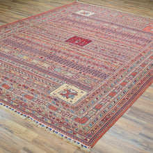 Load image into Gallery viewer, Decorative rug with intricate patterns on a wooden floor