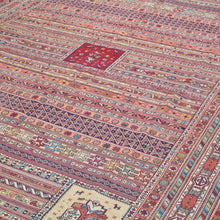 Load image into Gallery viewer, Close-up of a patterned rug with intricate designs and colors.