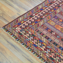 Load image into Gallery viewer, Colorful patterned rug on a wooden floor