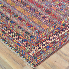 Load image into Gallery viewer, Colorful patterned rug on a wooden floor