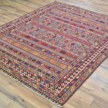 Load image into Gallery viewer, Multicolored patterned rug on a wooden floor