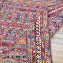 Load image into Gallery viewer, Multicolored patterned fabric on a wooden floor