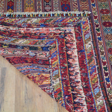 Load image into Gallery viewer, Colorful patterned rug on a wooden floor