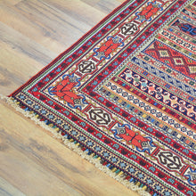 Load image into Gallery viewer, Decorative rug with intricate patterns on a wooden floor