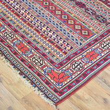 Load image into Gallery viewer, Colorful patterned rug on a wooden floor