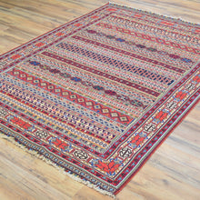 Load image into Gallery viewer, Decorative rug with intricate patterns on a wooden floor