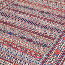 Load image into Gallery viewer, Close-up of a colorful patterned fabric with geometric designs.