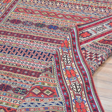 Load image into Gallery viewer, Multicolored patterned fabric with intricate designs on a wooden floor.