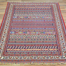 Load image into Gallery viewer, Colorful patterned rug on a wooden floor