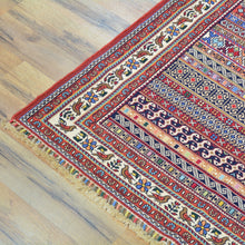 Load image into Gallery viewer, Colorful patterned rug on a wooden floor