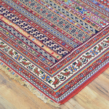 Load image into Gallery viewer, Colorful patterned rug on a wooden floor