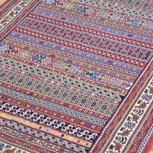 Load image into Gallery viewer, Close-up of a colorful patterned fabric with intricate designs.