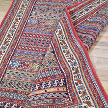 Load image into Gallery viewer, Colorful patterned rug on a wooden floor