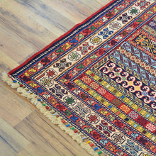 Load image into Gallery viewer, Colorful patterned rug on a wooden floor
