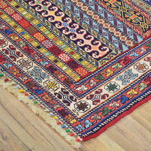 Load image into Gallery viewer, Colorful patterned rug on a wooden floor